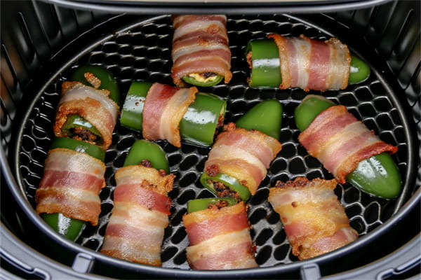 Place the wrapped jalapenos in the air fryer basket